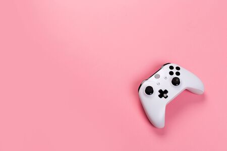 Joystick gaming controller isolated on pink background , Video game console developed Interactive Entertainmentの写真素材