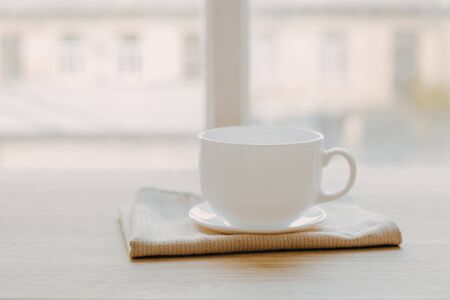 blurred background of kitchen and white cup of teaの写真素材