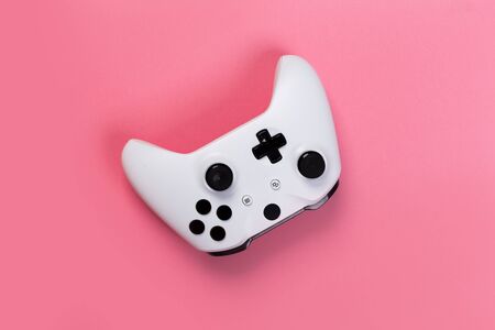 Joystick gaming controller isolated on pink background , Video game console developed Interactive Entertainmentの写真素材
