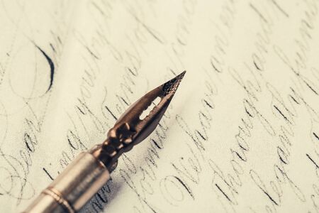 Fountain pen on an ancient handwritten letter. Old story. Retro style.の写真素材