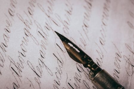 Fountain pen on an ancient handwritten letter. Old story. Retro style.の写真素材