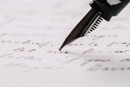 fountain pen on paper with ink text closeupの写真素材