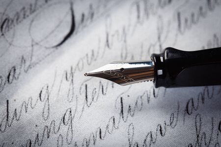 fountain pen on paper with ink text closeupの写真素材