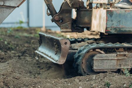 Excavator mechanical part for digging  for construction.close up of tracked wheel on a construction...