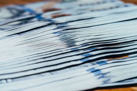 Close up of a lot of american dollar bills on a wooden tableの写真素材
