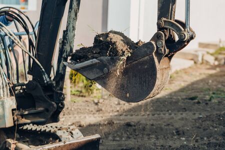 Bucket of a small crawler excavator. Excavator mechanical part for digging. Machines and mechanisms for construction.の写真素材