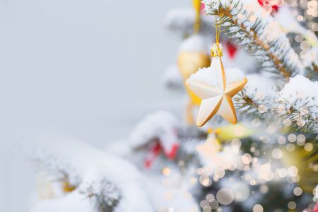 Christmas tree in snow background. New Year composition with fir tree, balls and lights and bokeh.
Christmas and New Year festive background.の写真素材
