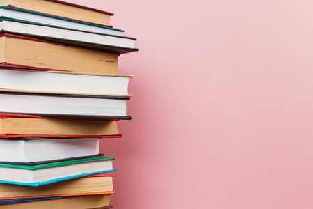 Simple Simple composition of many hardback books, unprocessed books on a wooden table and a pale...