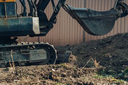 Excavator mechanical part for digging  for construction.close up of tracked wheel on a construction...