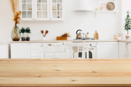 Wooden board empty table in front of a blurred background. Perspective brown wood with a blurred background of the kitchen and kitchen equipment - can be used to demonstrate or assemble your products.の写真素材