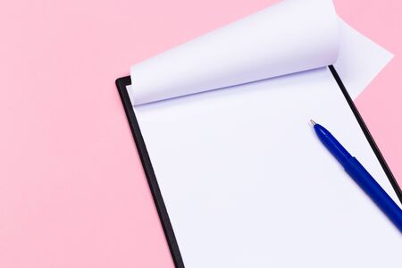Clipboard with white sheet and pen on a colored background. View from above. space for textの写真素材