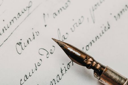 Fountain pen on an ancient handwritten letter. Old story. Retro style.の写真素材
