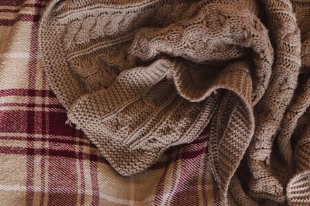 winter concept of home warmth and comfortÑŽ Crumpled gray beige knit blanket. Soft and warm fabric...