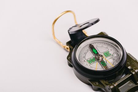 Modern navigation metal tourist compass on a light background. travel or search conceptの写真素材