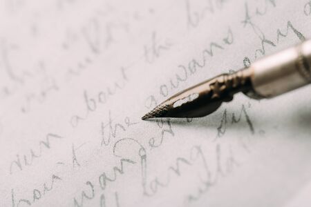 Fountain pen on an ancient handwritten letter. Old story. Retro style.