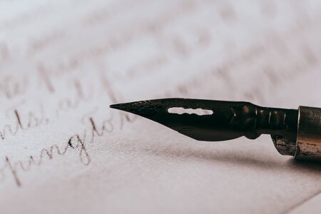 Fountain pen on an ancient handwritten letter. Old story. Retro style.