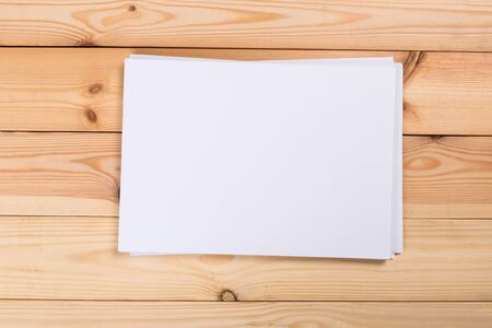 Top view of modern desk office workplace with  a4 paper. Blank branding template. Photo blank form. Mock up for portfolio design.の写真素材