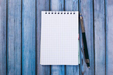 top view of blank open notebook paper on wooden background, office equipment, school stationary and education conceptの写真素材