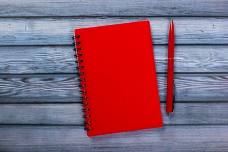 top view of blank open notebook paper on wooden background, office equipment, school stationary and education conceptの写真素材