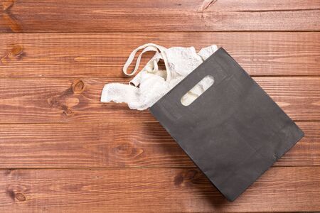 Delicate set of lingerie in a gift bag. Copy space. The concept of clothing, accessories, shopping.の写真素材