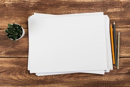 Top view of modern desk office workplace with  a4 paper. Blank branding template. Photo blank form....