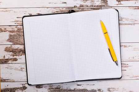 blank notebook with pen on a wooden table, business concept concept of a new workplace