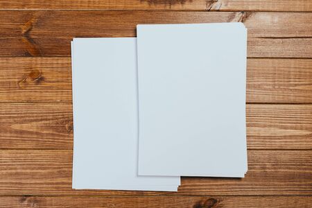 Top view of modern desk office workplace with  a4 paper. Blank branding template. Photo blank form....