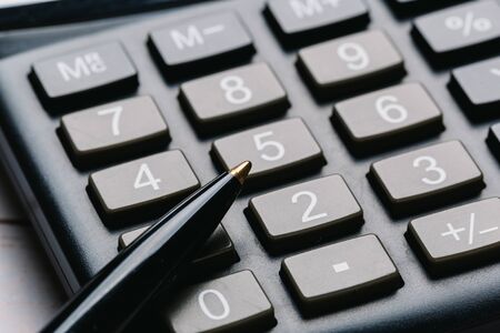 black calculator, Business and Finance accounting concept on wooden table
