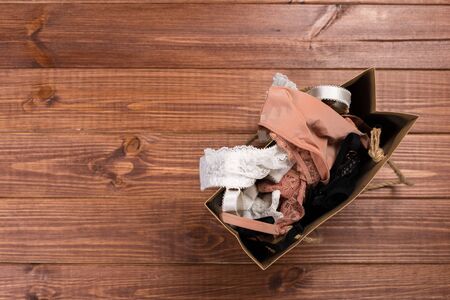 Delicate set of lingerie in a gift bag. Copy space. The concept of clothing, accessories, shopping.の写真素材