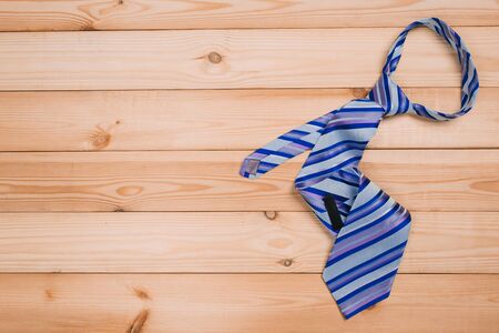 color male tie on a wooden table. shopping concept