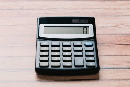 black calculator, Business and Finance accounting concept on wooden table