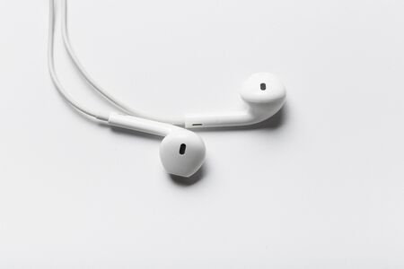 White modern headphones with a headset on a light gray background. concept of digital musicの写真素材