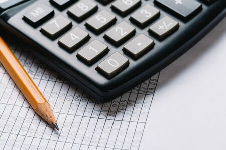 black calculator and pencil, Business and Finance accounting concept on wooden table