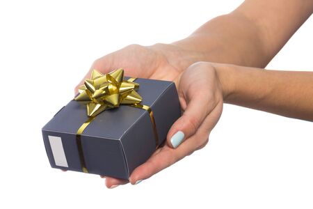 female hand holds a beautiful gift box with a bow isolated on white background