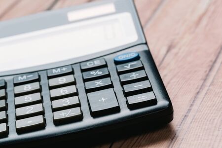 black calculator, Business and Finance accounting concept on wooden table