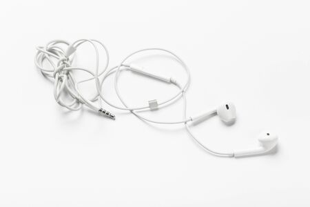 White modern headphones with a headset on a light gray background. concept of digital musicの写真素材