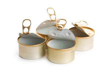 several open empty tin cans on a white background