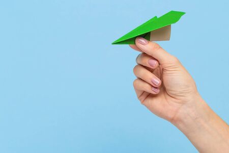 Hands holding the sign of paper airplane or message on blue studio background. Negative space, advertising. Social media, showing meaning, communicationの写真素材