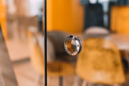 round metal doorknob in the glass door of a modern officeの写真素材