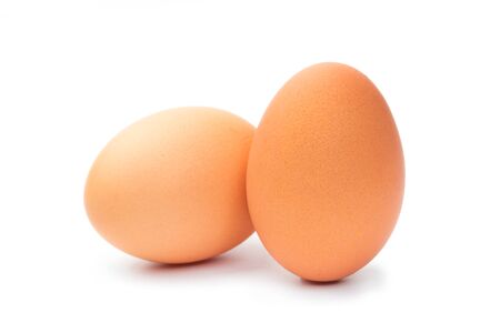 Two brown chicken eggs on a white backgroundの写真素材