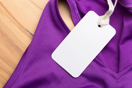 Clothing tag, label blank mockup on a clothes, to place your design.  fashion, people and shopping concept - close up price tag of clothing itemの写真素材