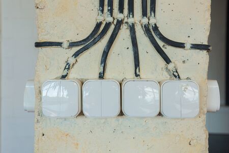 external wiring of black wires in a column for light switches in an office room in a loft styleの写真素材