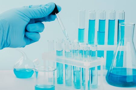 Laboratory glassware with test tubes. scientific laboratory equipment. hands of a scientific...