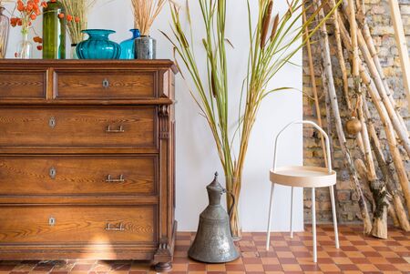 old antique old mahogany chest of drawers in a room with additional decor