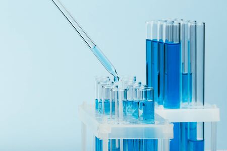 Laboratory glassware with a dropper dripping liquid into a test tube. scientific laboratory test...