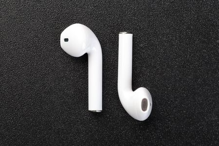 Modern wireless  headphones on a dark black background. Modern technology conceptの写真素材