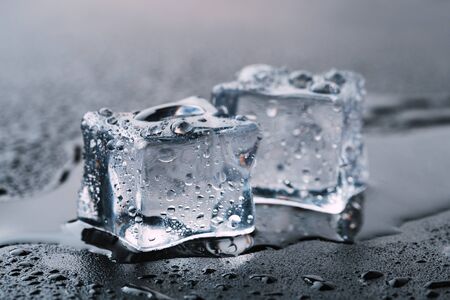 Ice cubes square with drops water clean on blue background.の写真素材