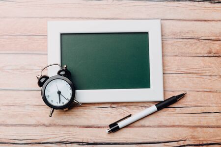 Clean vintage chalk board on a wooden table. Top viewの写真素材