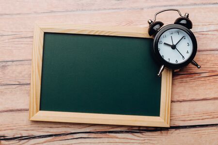 Clean vintage chalk board on a wooden table. Top view