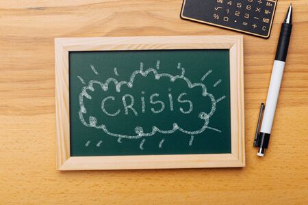 Crisis management of the global economy and stock markets, the concept of the financial crisis. graphics on chalk boardの写真素材
